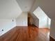 Attic area with hardwood floors and dormer window, offering natural light at 4060 San Marco Way, Douglasville, GA 30135