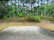 A concrete patio in a backyard area features a beautiful tree line at 4060 San Marco Way, Douglasville, GA 30135