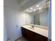Bathroom featuring a marble sink countertop with a large mirror and cabinets at 4060 San Marco Way, Douglasville, GA 30135
