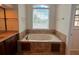 Bathroom with jetted tub and tile surround at 4060 San Marco Way, Douglasville, GA 30135