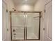 Bright bathroom features a shower over tub combo with sliding glass door at 4060 San Marco Way, Douglasville, GA 30135