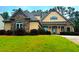Charming home with a combination of stone and siding, complemented by a lush green lawn and mature trees at 4060 San Marco Way, Douglasville, GA 30135
