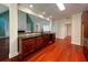 Kitchen with a breakfast bar overlooking the living room, rich wood cabinets, dark countertops, and hardwood floors at 4060 San Marco Way, Douglasville, GA 30135