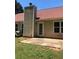 An outdoor space features a chimney, back door, patio and a patch of green grass on a sunny day at 75 Oak Hill Dr, Covington, GA 30016