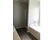 Bathroom features a tub next to a walk-in shower, with new gray flooring at 75 Oak Hill Dr, Covington, GA 30016
