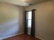 Cozy bedroom with neutral walls, wood floors, and a window with elegant curtains for added privacy and charm at 75 Oak Hill Dr, Covington, GA 30016