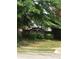 Community sign, 'Oak Hill', with manicured hedges and mature shade trees at 75 Oak Hill Dr, Covington, GA 30016