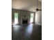 Open living room area features wood-look flooring, bright windows and a fireplace with an elegant white mantel at 75 Oak Hill Dr, Covington, GA 30016