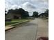 Residential street in a quiet neighborhood with well-maintained lawns and mature trees at 75 Oak Hill Dr, Covington, GA 30016