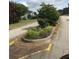 Landscaped median with mature trees lining the street and multiple parked cars at 75 Oak Hill Dr, Covington, GA 30016