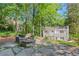 Relax in this peaceful backyard oasis with a stone patio, fire pit, and surrounded by mature trees and lush greenery at 770 Wellesley Nw Dr, Atlanta, GA 30305