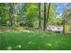 Spacious backyard with manicured lawn and mature trees creating a private, park-like setting for outdoor enjoyment at 770 Wellesley Nw Dr, Atlanta, GA 30305