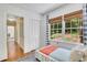 Bedroom featuring a bed, hardwood floor, closet, and a window with a view to backyard at 770 Wellesley Nw Dr, Atlanta, GA 30305