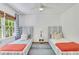 Bright bedroom has two twin beds, a ceiling fan, a window with curtains, and an area rug at 770 Wellesley Nw Dr, Atlanta, GA 30305