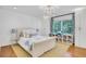 Bright bedroom features a large bed, hardwood floors, decorative lighting, and bookshelves at 770 Wellesley Nw Dr, Atlanta, GA 30305