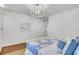 Well-lit bedroom with hardwood floor, light fixture, and queen size bed with many pillows at 770 Wellesley Nw Dr, Atlanta, GA 30305