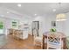 Well-lit dining area with white chairs and a decorative light fixture at 770 Wellesley Nw Dr, Atlanta, GA 30305