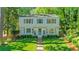Charming two-story home with brick walkway and manicured lawn surrounded by mature trees at 770 Wellesley Nw Dr, Atlanta, GA 30305