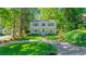 Classic two-story home with a neatly manicured front lawn, charming landscaping, and a welcoming circular driveway at 770 Wellesley Nw Dr, Atlanta, GA 30305