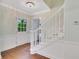 Inviting foyer with hardwood floors, wainscoting, wallpaper, and a staircase with white banister at 770 Wellesley Nw Dr, Atlanta, GA 30305