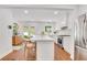 Open-concept kitchen featuring an island with seating, stainless steel appliances, and hardwood floors at 770 Wellesley Nw Dr, Atlanta, GA 30305