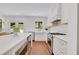 Bright, renovated kitchen with stainless steel appliances, island with seating, and doors to the outside at 770 Wellesley Nw Dr, Atlanta, GA 30305