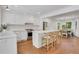 Bright, airy kitchen with white cabinets, stainless steel appliances, island with seating, and breakfast area at 770 Wellesley Nw Dr, Atlanta, GA 30305