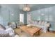 Bright living room with panelled walls, beaded chandelier, plush furniture and an inviting natural fiber rug at 770 Wellesley Nw Dr, Atlanta, GA 30305