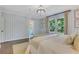 Relaxing bedroom with an ensuite bathroom, striped walls, large window and natural light at 770 Wellesley Nw Dr, Atlanta, GA 30305