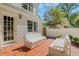 A lovely red brick patio with white cushioned benches offers a cozy outdoor seating area near the home's entrance at 770 Wellesley Nw Dr, Atlanta, GA 30305