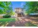 Rear exterior of home featuring a deck and stairs overlooking a spacious backyard at 12237 Cypress Ln, Fayetteville, GA 30215