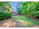 Enjoy the tranquil backyard with lush greenery and deck access perfect for outdoor entertaining at 12237 Cypress Ln, Fayetteville, GA 30215