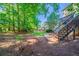 The beautiful backyard features a spacious lawn, surrounded by mature trees, offering plenty of privacy at 12237 Cypress Ln, Fayetteville, GA 30215