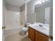 Compact bathroom featuring a combined tub and shower, a single sink vanity, and tile flooring at 12237 Cypress Ln, Fayetteville, GA 30215