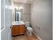 A cozy bathroom featuring a single sink vanity, toilet, and neutral wall paint at 12237 Cypress Ln, Fayetteville, GA 30215