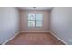 Bedroom with neutral walls and carpet, offering a clean and simple space with a bright window at 12237 Cypress Ln, Fayetteville, GA 30215