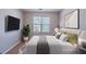Bright bedroom with modern decor, stylish bed, and flat screen TV for comfortable living at 12237 Cypress Ln, Fayetteville, GA 30215