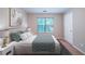 Bedroom with modern decor featuring a stylish bed, and large window creating a relaxing retreat at 12237 Cypress Ln, Fayetteville, GA 30215