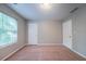 Bedroom with neutral walls, carpet, and window with blinds with two paneled doors at 12237 Cypress Ln, Fayetteville, GA 30215