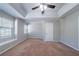 Large bedroom with tray ceiling, carpet flooring, and a window seat at 12237 Cypress Ln, Fayetteville, GA 30215
