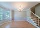 Bright dining room with hardwood floors, a staircase, and natural light from a bay window at 12237 Cypress Ln, Fayetteville, GA 30215