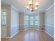 Charming dining room with hardwood floors, bay window, and elegant lighting fixture, perfect for gatherings at 12237 Cypress Ln, Fayetteville, GA 30215