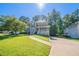 Charming two-story home with landscaped yard and a welcoming front porch with green grass and blue skies at 12237 Cypress Ln, Fayetteville, GA 30215