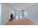 Open living room with hardwood floors, a fireplace and large window view at 12237 Cypress Ln, Fayetteville, GA 30215
