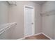 Carpeted walk-in closet has built-in shelving at 12237 Cypress Ln, Fayetteville, GA 30215