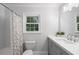 Bright bathroom featuring modern vanity, white subway tiles, and colorful shower curtain at 1435 Withmere Ln, Atlanta, GA 30338