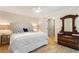 Main bedroom featuring hardwood floors, neutral paint, and large antique dresser with mirror at 1435 Withmere Ln, Atlanta, GA 30338