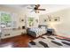Cozy bedroom with hardwood floors, plantation shutters, and a fun patterned rug at 1435 Withmere Ln, Atlanta, GA 30338
