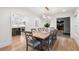 Bright dining room features hardwood floors, modern lighting, and large wood table with seating for eight at 1435 Withmere Ln, Atlanta, GA 30338