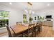 Dining room showcases hardwood floors, modern lighting, and a large wooden table, plus view to the living room at 1435 Withmere Ln, Atlanta, GA 30338